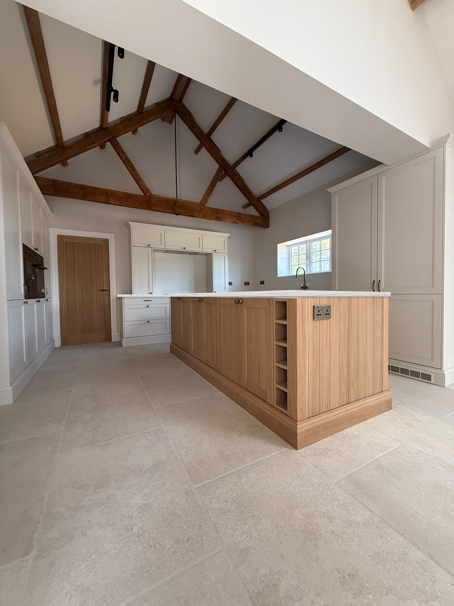 Bespoke oak kitchen island with wine storage, built by Rymax Carpentry and Building